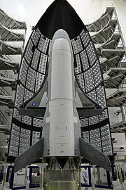 2006年11月，美國空軍宣布以X-37A為基礎發展X-37B，稱為軌道試驗飛行器（Orbital Test Vehicle，OTV），由美國空軍下屬的快速反應能力辦公室（Rapid Capabilities Office）主持，同時NASA與美國空軍研究實驗室（Air Force Research Laboratory，AFRL）也參與研製。原定於2007年底至2008條規初試飛的X-37B，幾經推遲後將首飛時間改到了2010年。2010年4月22日，第一架被命名為OTV-1的X-37B從美國佛羅里達州卡納維拉爾角空軍基地搭乘阿特拉斯-5型運載火箭發射升空，並預計在加利福尼亞州范登堡空軍基地降落。