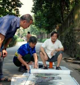 圖為李先生和他的胞妹在展出現場為觀眾釋義。